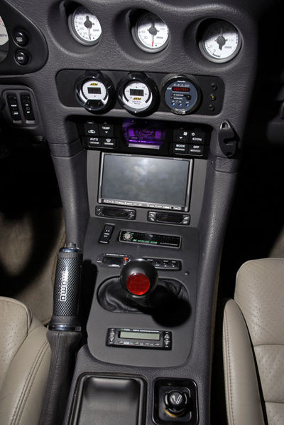 Custom center console area of 3000GT VR-4 showing center gauges and custom installation.